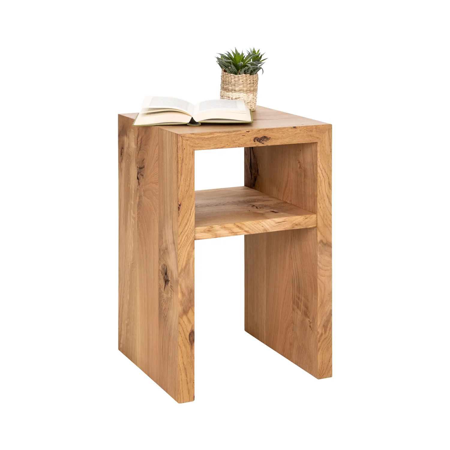 Nachttisch aus Eichenholz mit einem Ablagegefach, darauf Buch und Pflanze